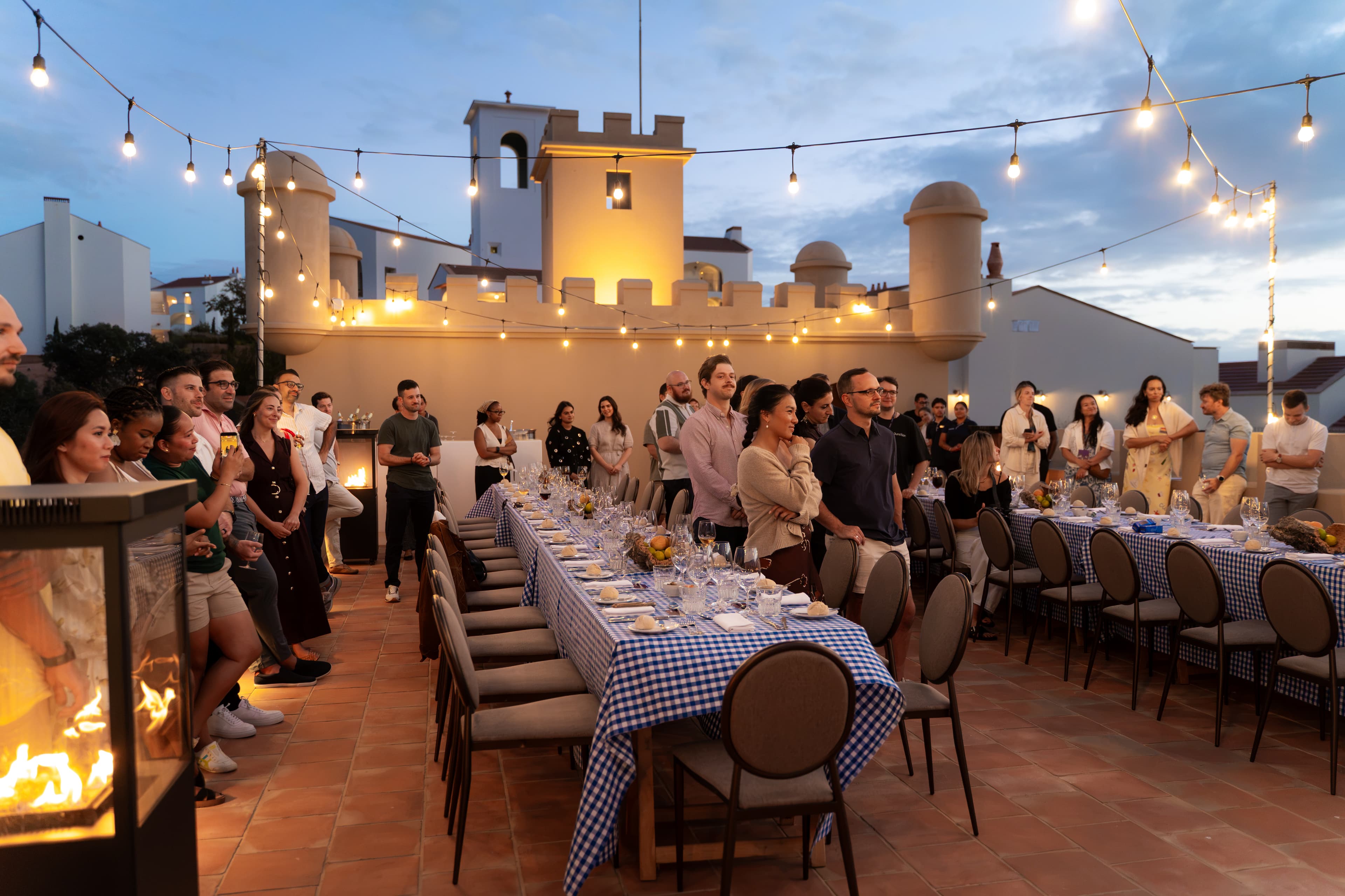 Team gathered for a rooftop dinner at dusk